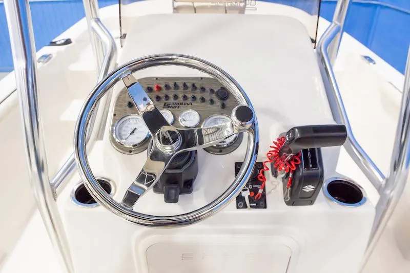 Slide: The Image of Manufacturer Provided Image: Steering console of 2026 Carolina Skiff 19 LS boat with gauges and controls. - 7