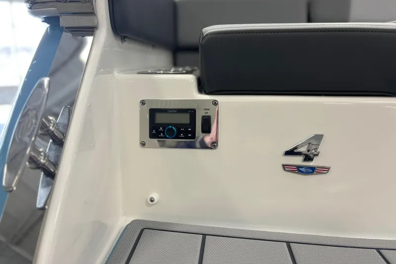 Slide: The Image of 2026 Chaparral SSX 4 boat interior with control panel and emblem. - 11