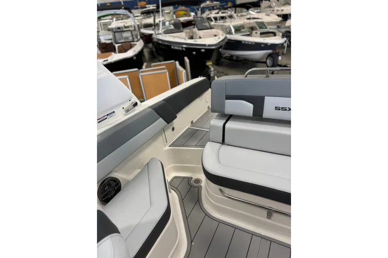 Slide: The Image of 2026 Chaparral SSX 4 boat interior with sleek seating and modern design in showroom. - 15