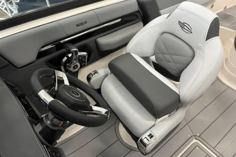 Slide: The Image of 2026 Chaparral SSX 4 boat interior with sleek steering wheel and luxurious seating. - 17
