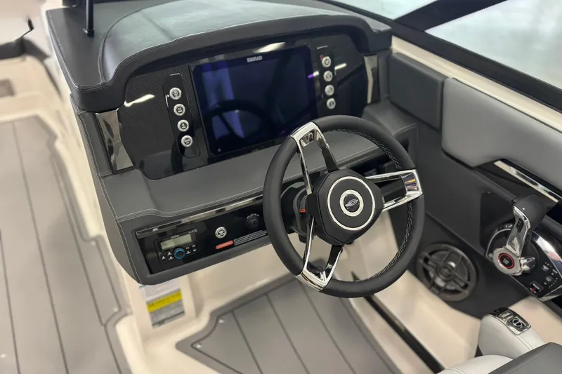 Slide: The Image of 2026 Chaparral SSX 4 boat dashboard with steering wheel and control panel. - 18