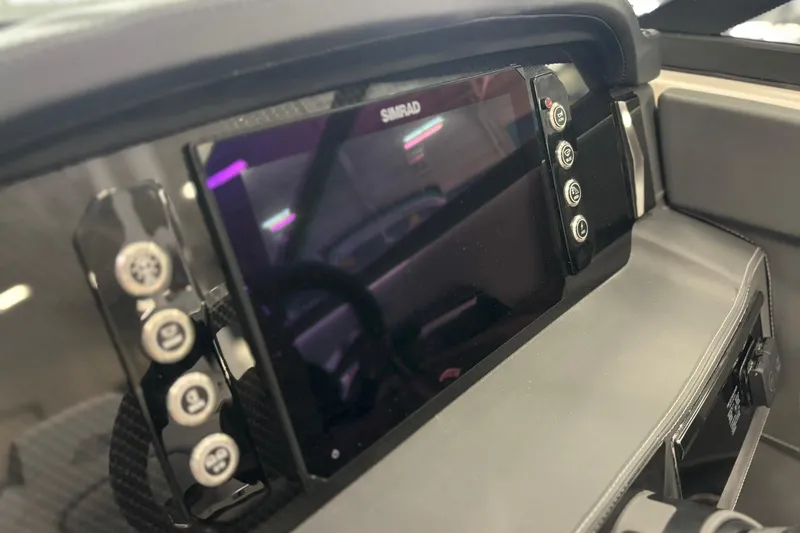 Slide: The Image of 2026 Chaparral SSX 4 dashboard featuring a Simrad display and control buttons. - 22