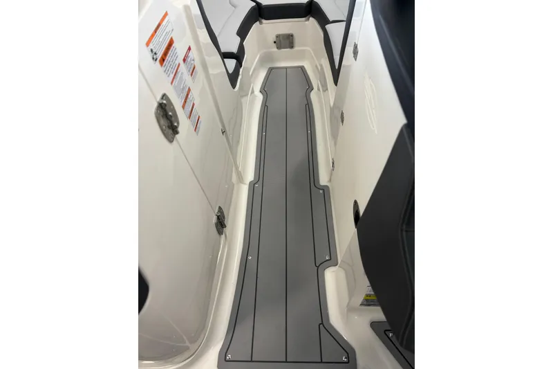 Slide: The Image of 2026 Chaparral SSX 4 boat interior walkway with sleek gray flooring. - 23