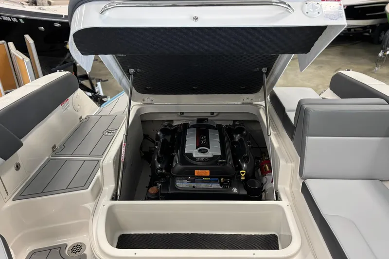 Slide: The Image of 2026 Chaparral SSX 4 boat engine compartment with open hatch, showcasing engine details. - 27