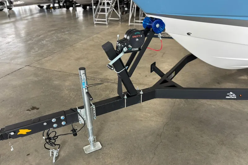 Slide: The Image of 2026 Chaparral SSX 4 boat trailer hitch in a garage setting. - 6