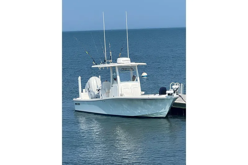 The Image of 2024 Regulator 26XO boat docked on calm blue water. - 0