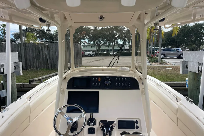 Slide: The Image of 2021 Grady-White Canyon 271 boat interior with steering wheel and control panel. - 11