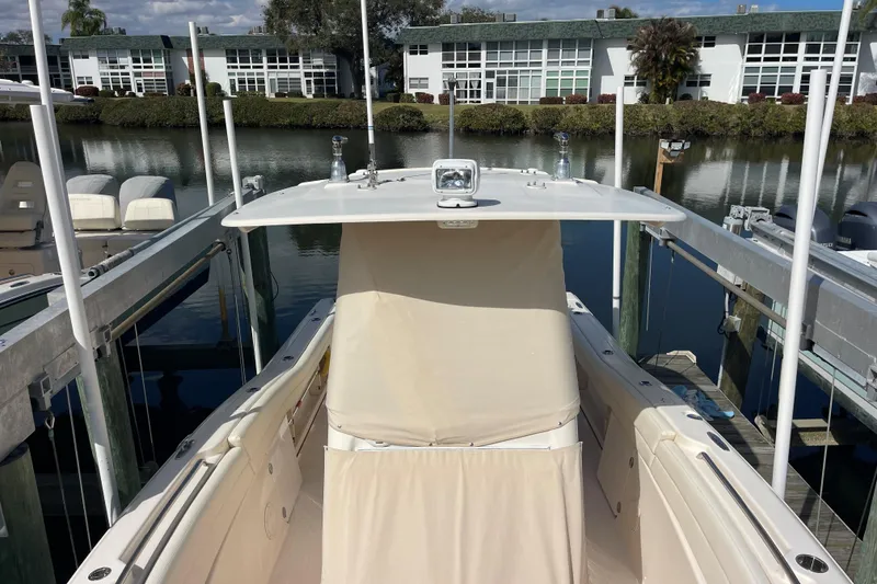 Slide: The Image of 2021 Grady-White Canyon 271 boat docked near waterfront buildings. - 13