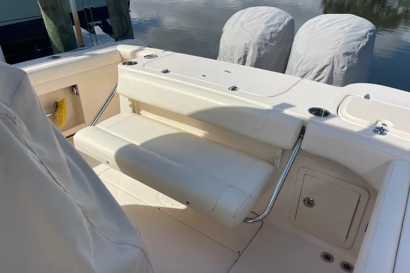 Slide: The Image of 2021 Grady-White Canyon 271 boat interior with seating and covered engines. - 14