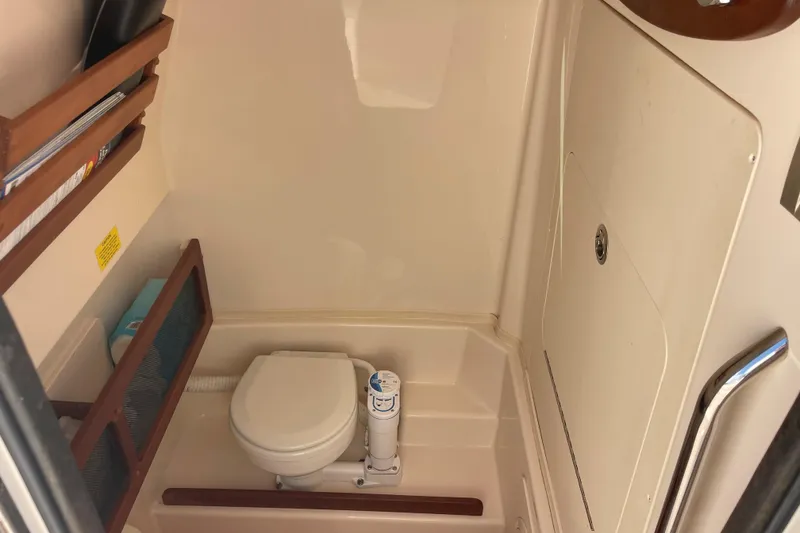 Slide: The Image of 2021 Grady-White Canyon 271 boat interior with compact marine toilet. - 15
