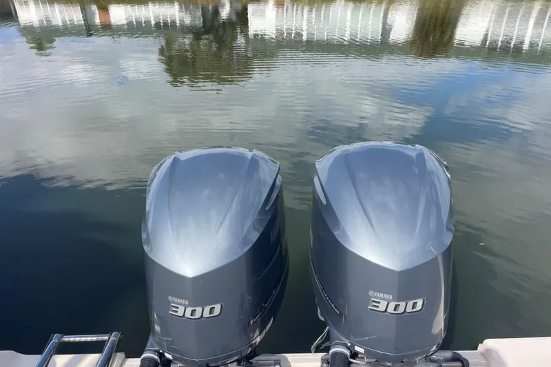 Slide: The Image of Twin Yamaha 300 engines on a 2021 Grady-White Canyon 271 boat, reflecting on water. - 16
