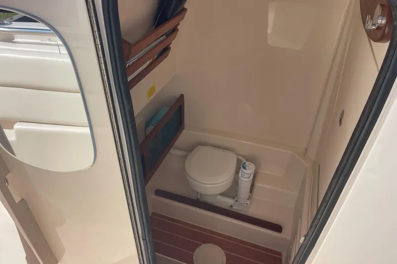 Slide: The Image of 2021 Grady-White Canyon 271 boat interior with compact marine toilet. - 17
