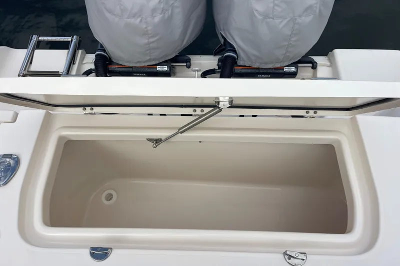 Slide: The Image of Open storage compartment on 2021 Grady-White Canyon 271 boat, with dual Yamaha engines. - 3