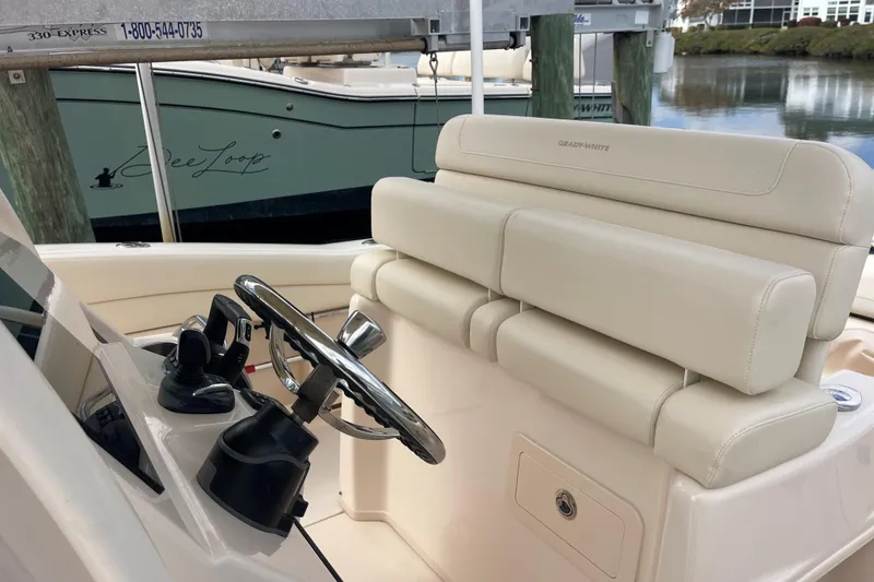Slide: The Image of 2021 Grady-White Canyon 271 boat interior with steering wheel and seating. - 5