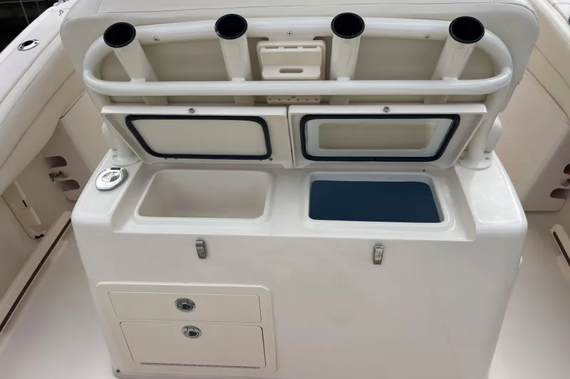 Slide: The Image of 2021 Grady-White Canyon 271 boat interior with storage compartments and rod holders. - 8