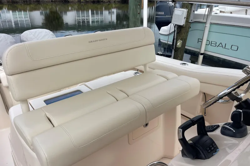 Slide: The Image of 2021 Grady-White Canyon 271 boat interior with beige seating and control panel. - 9
