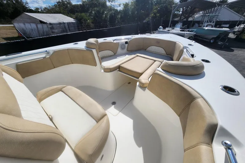 Slide: The Image of 2018 Key West 263 FS boat interior with beige seating and spacious layout. - 10