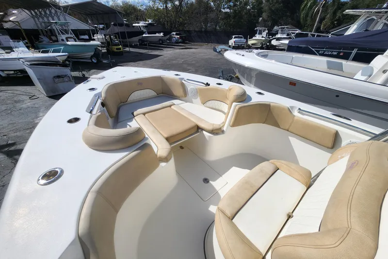 Slide: The Image of 2018 Key West 263 FS boat with spacious seating in a marina setting. - 11