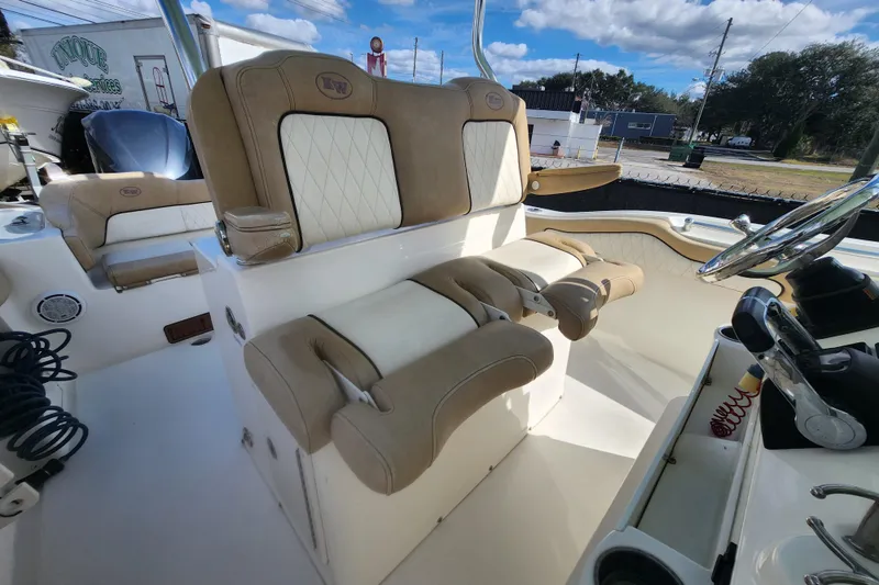 Slide: The Image of 2018 Key West 263 FS boat interior with beige seating and steering wheel. - 6