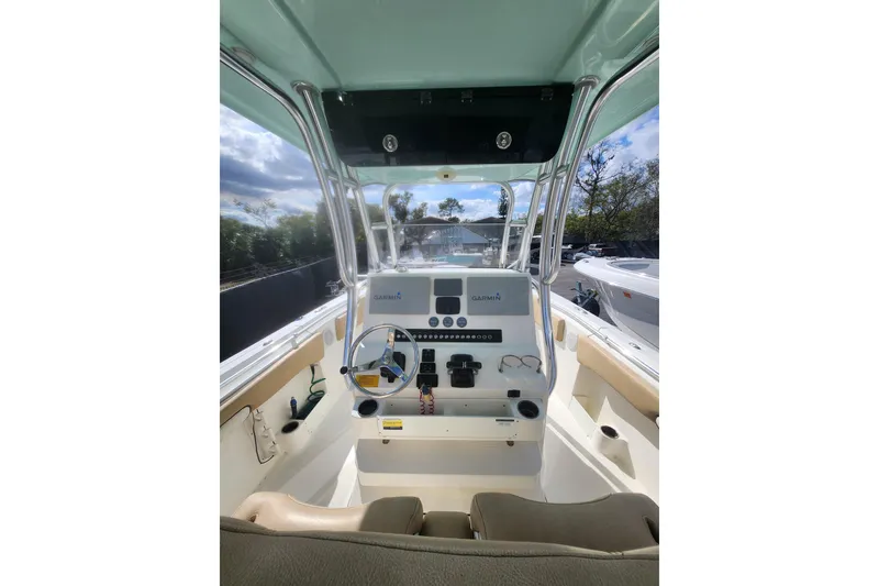 Slide: The Image of 2018 Key West 263 FS boat cockpit with steering wheel and Garmin navigation system. - 8