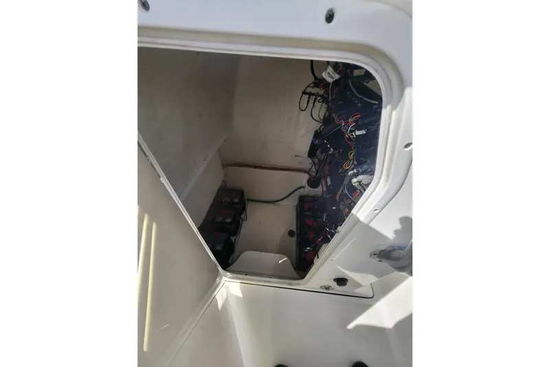 Slide: The Image of 2018 Key West 263 FS boat electrical compartment with wiring and batteries. - 9
