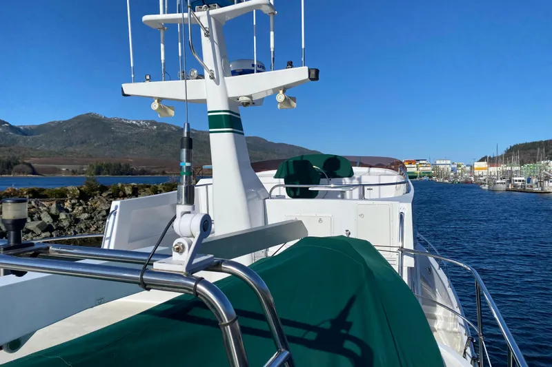 Slide: The Image of 2003 Northern Marine 57 Raised Pilothouse yacht docked in scenic marina with mountains. - 16