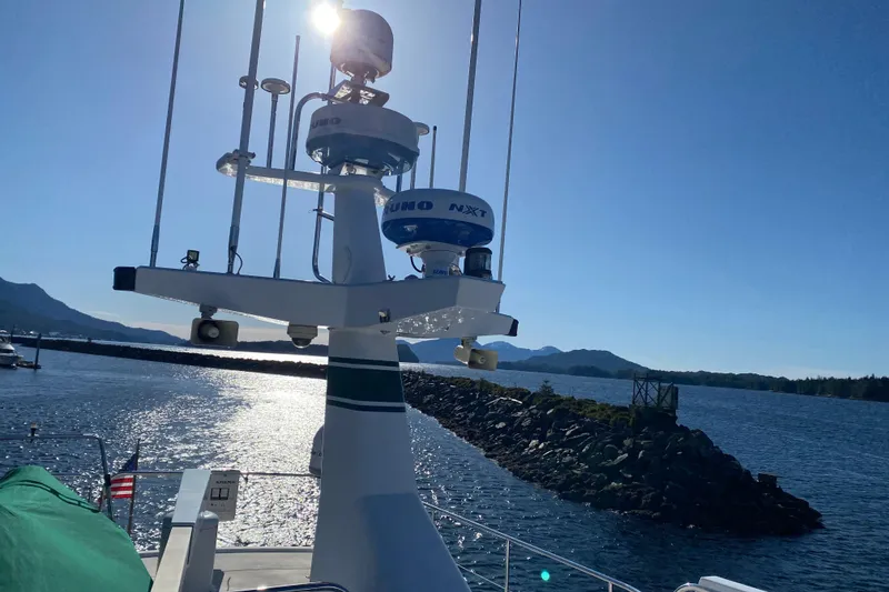 Slide: The Image of Northern Marine 57 Raised Pilothouse yacht, 2003, with radar equipment, on a sunny day by the water. - 18