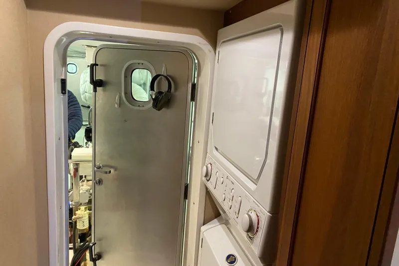 Slide: The Image of Laundry area inside 2003 Northern Marine 57 Raised Pilothouse yacht with metal door. - 25