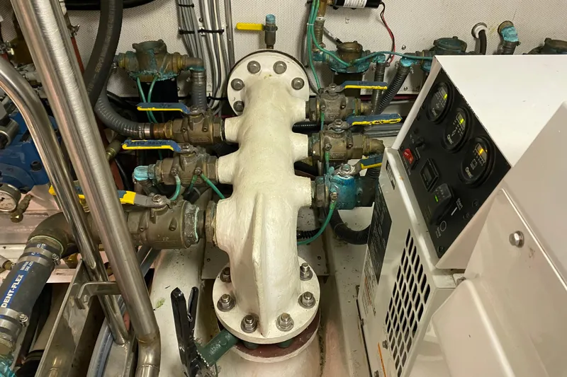 Slide: The Image of Engine room of 2003 Northern Marine 57 Raised Pilothouse with gauges and valves. - 30