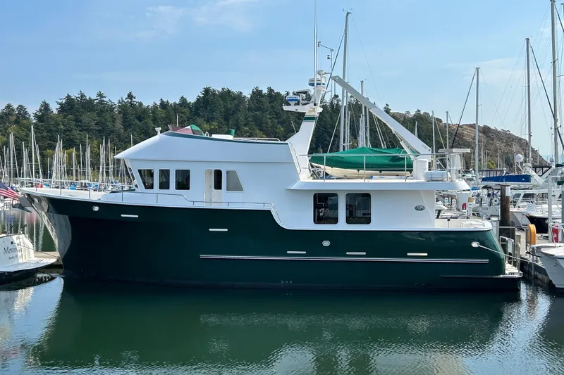 Slide: The Image of 2004 Northern Marine 57 Raised Pilothouse yacht docked in a marina. - 34