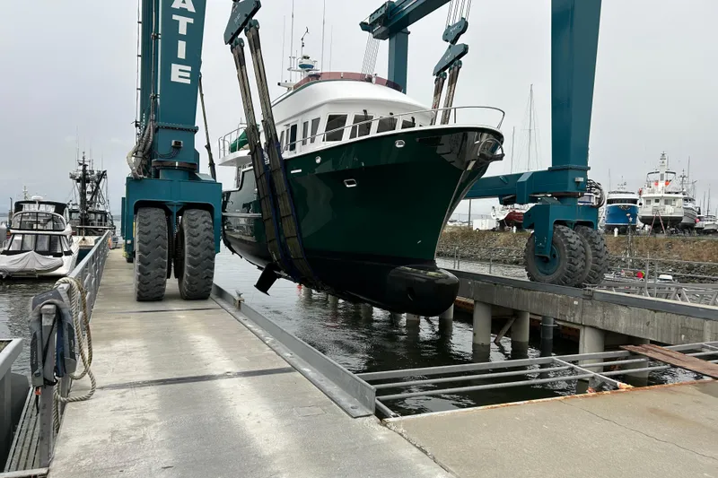 Slide: The Image of Northern Marine 57 Raised Pilothouse yacht being lifted at a marina, 2004 model. - 39