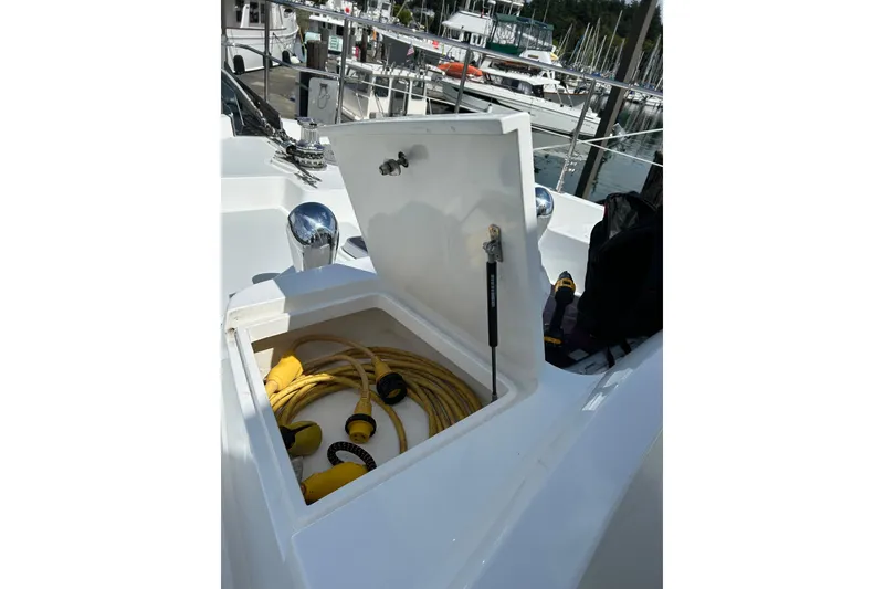 Slide: The Image of Open storage compartment on 2004 Northern Marine 57 Raised Pilothouse yacht with yellow cables. - 42