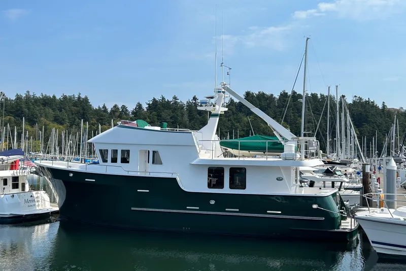 Slide: The Image of 2004 Northern Marine 57 Raised Pilothouse yacht docked in a marina. - 45