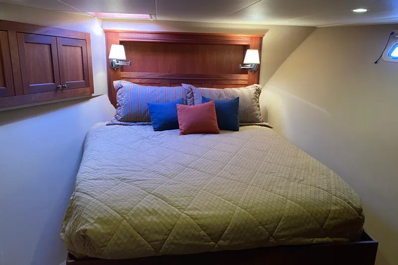 Slide: The Image of Cozy bedroom in 2003 Northern Marine 57 Raised Pilothouse yacht with elegant bedding. - 7