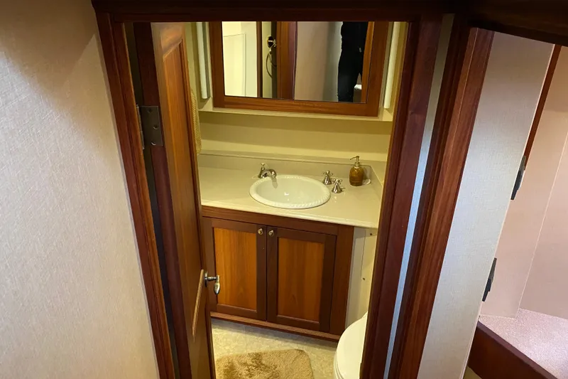 Slide: The Image of Bathroom interior of 2003 Northern Marine 57 Raised Pilothouse yacht, featuring wooden cabinetry. - 8