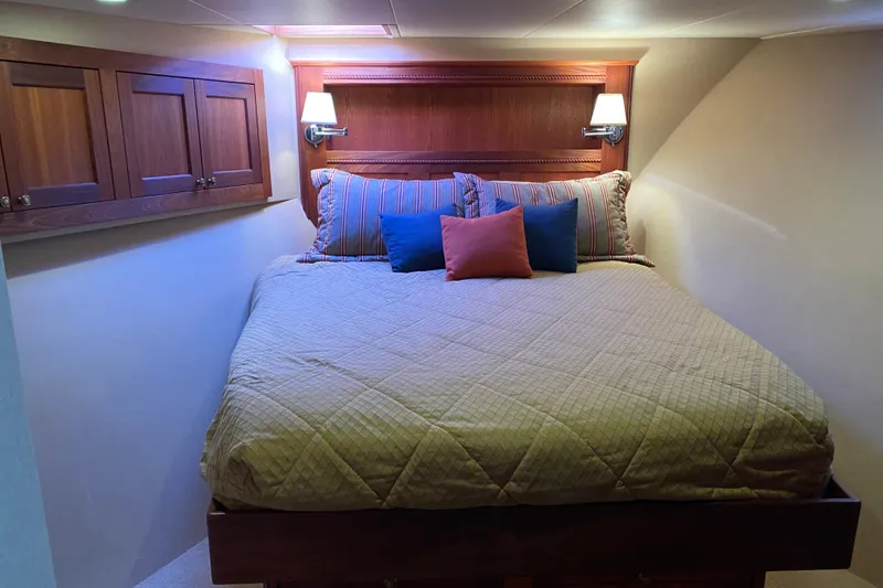 Slide: The Image of Cozy bedroom in 2003 Northern Marine 57 Raised Pilothouse yacht with elegant wood accents. - 9