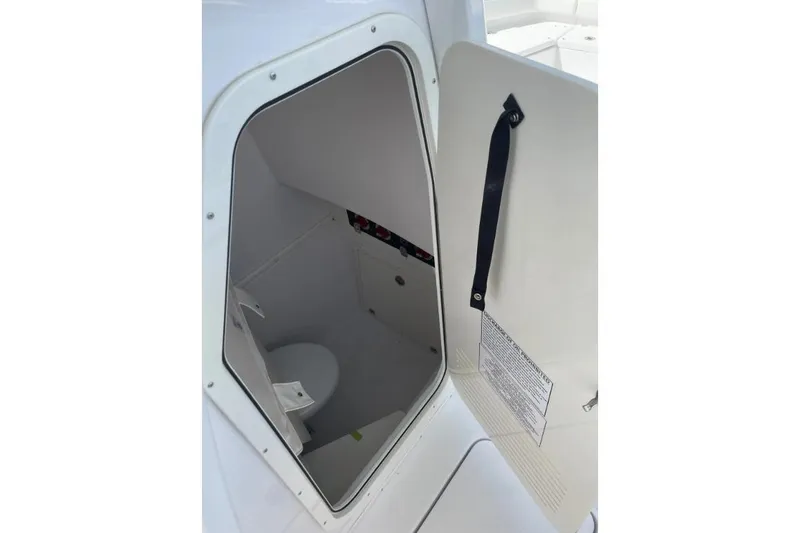 Slide: The Image of 2022 Century 2400 Center Console boat interior with open hatch and visible storage space. - 13