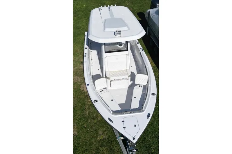 Slide: The Image of 2022 Century 2400 Center Console boat, aerial view, white exterior, on grass. - 15