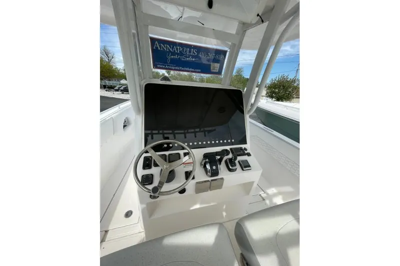 Slide: The Image of 2022 Century 2400 Center Console boat dashboard with steering wheel and controls. - 7