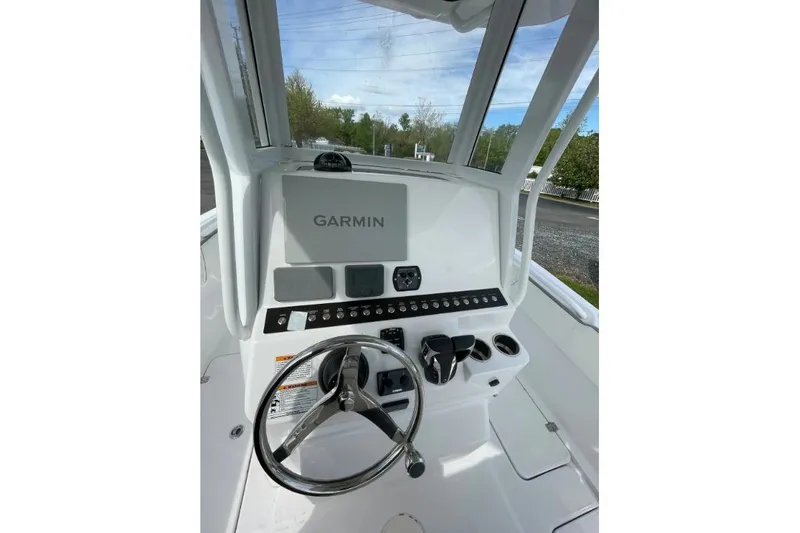 Slide: The Image of Century 2400 Center Console 2022 boat dashboard with Garmin navigation system. - 9