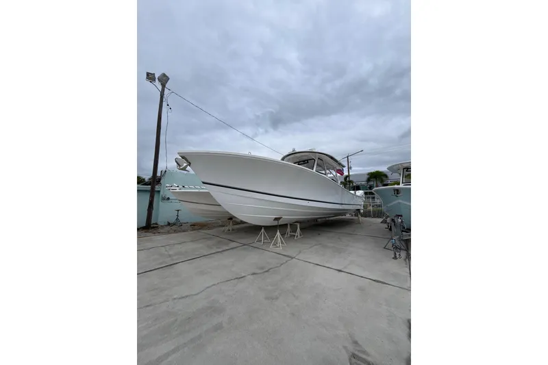 The Image of 2023 Regulator 41 boat on dry dock under cloudy sky. - 1