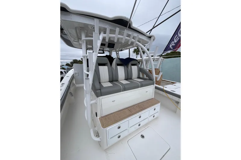 Slide: The Image of 2023 Regulator 41 boat seating area with storage drawers and cushioned seats. - 11