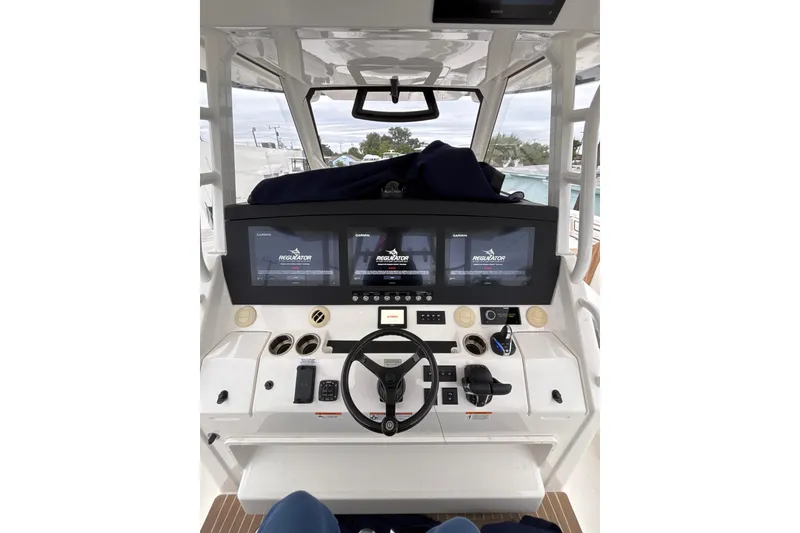 Slide: The Image of 2023 Regulator 41 boat helm with advanced navigation displays and controls. - 12