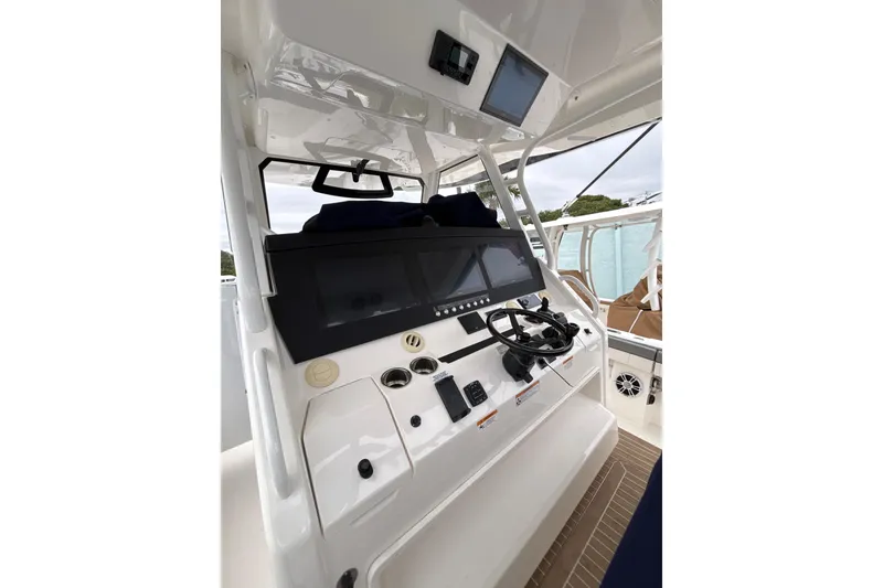 Slide: The Image of 2023 Regulator 41 boat helm with modern controls and navigation screens. - 9