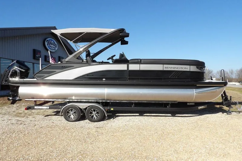 The Image of 2026 Bennington M Swingback 26 MSB pontoon boat on trailer, outdoor display. - 1