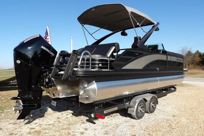 Slide: The Image of 2026 Bennington M Swingback 26 MSB pontoon boat on trailer, featuring Mercury outboard engine. - 13