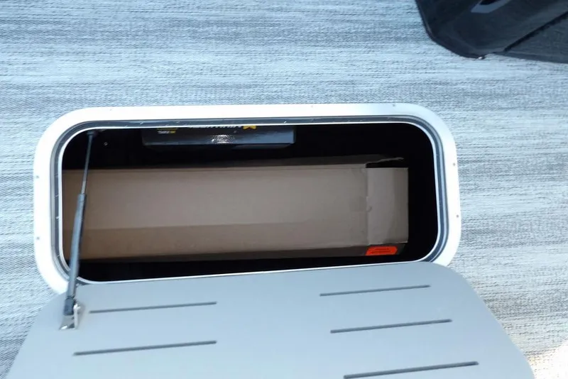 Slide: The Image of Storage compartment in 2026 Bennington M Swingback 26 MSB boat, open lid view. - 14