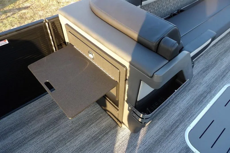 Slide: The Image of 2026 Bennington M Swingback 26 MSB boat interior with fold-out table and seating. - 15