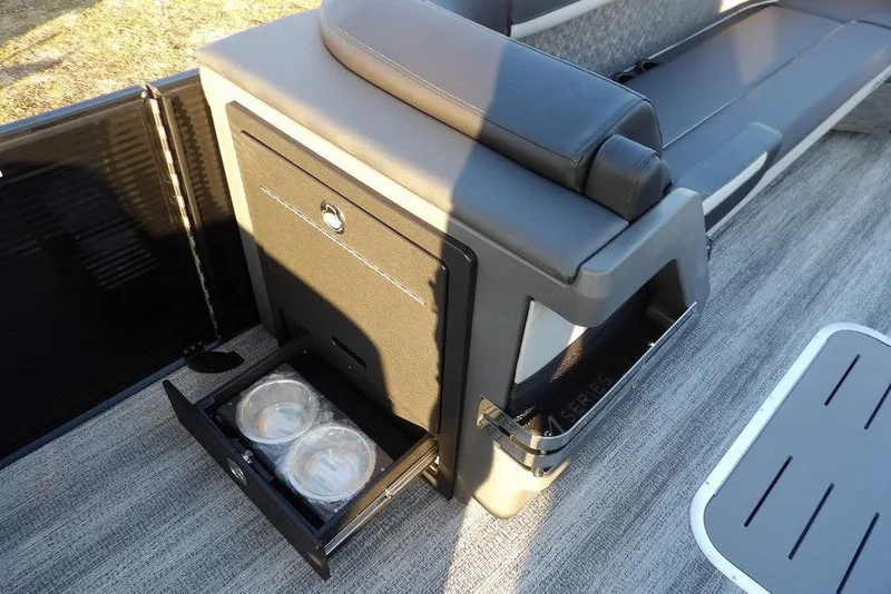 Slide: The Image of 2026 Bennington M Swingback 26 MSB boat interior with storage compartment and seating. - 16