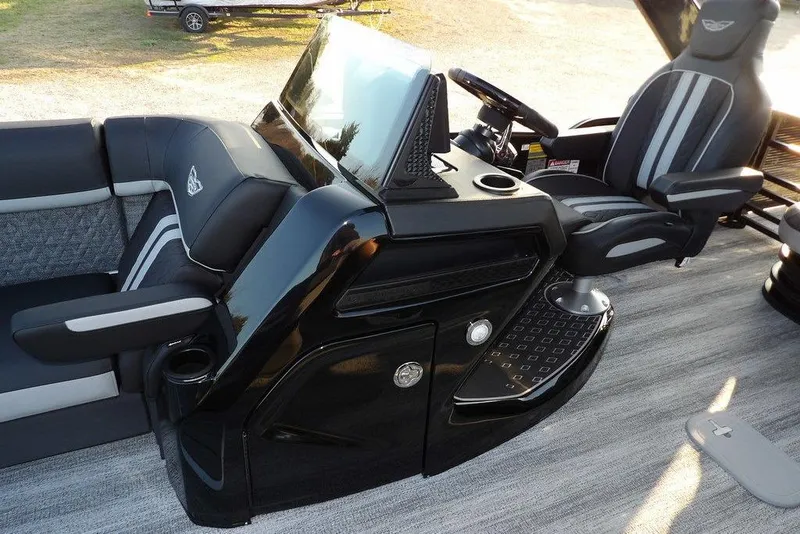 Slide: The Image of 2026 Bennington M Swingback 26 MSB boat interior with sleek black and gray seating. - 21